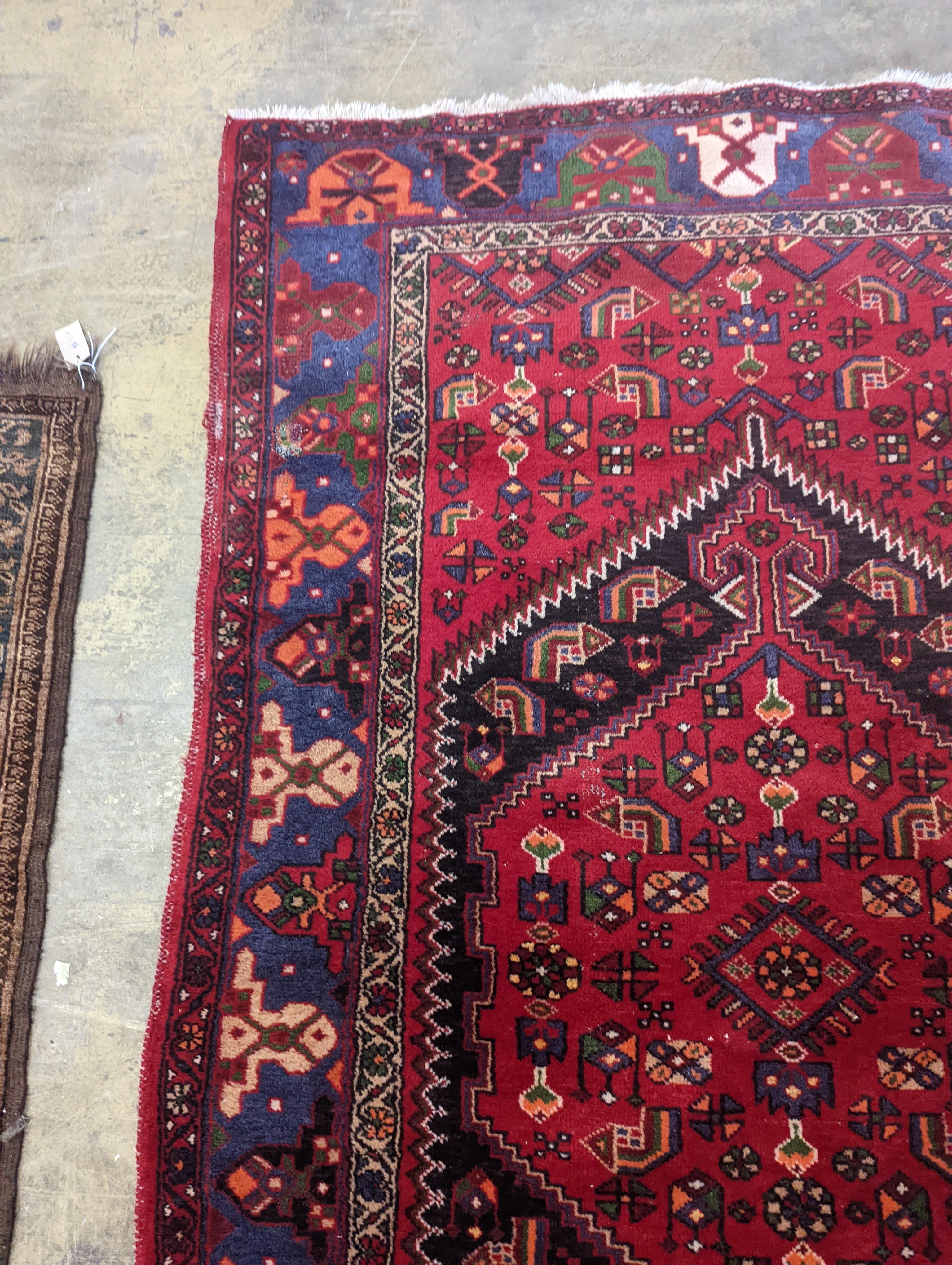 A Hamadan red ground rug, 220 x 130cm